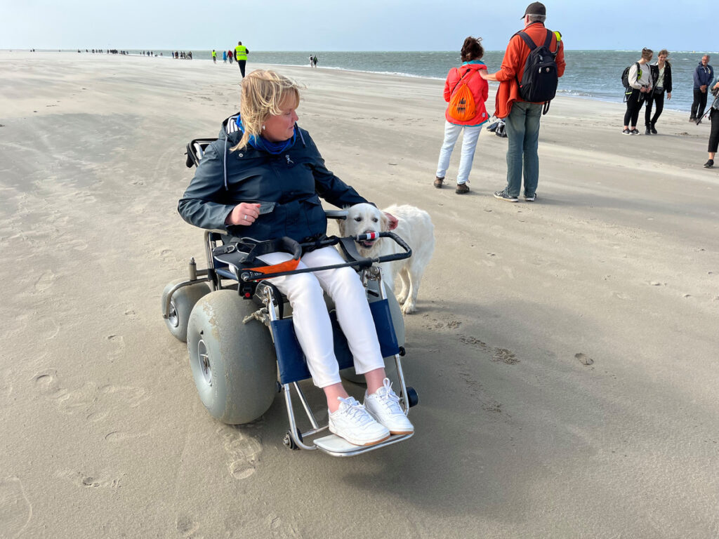 Saskia Dalebout met haar hond Pelle op het strand van Renesse. Saskia is naast blind ook nog rolstoelafhankelijk. © Saskia Dalebout